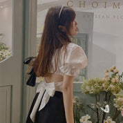 Bluse mit einer gebundenen Schleife auf dem Rücken